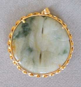 Jade pendant with 2 fish carved in each side gold frame  