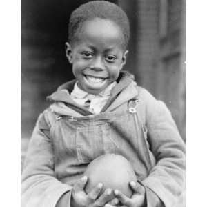  1929 photo African American boy holding a piece of fruit 
