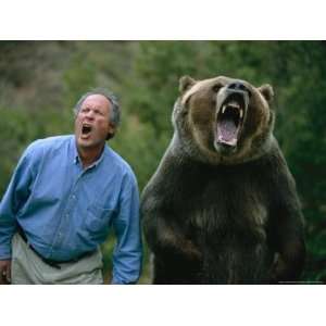  A Man and a Trained Grizzly Bear Snarl for the Camera 