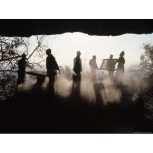 Backlit View of Men Sifting Soil and Working at the Entrance of the 