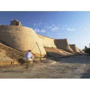  Man Cycling Past City Walls, Khiva, Uzbekistan 