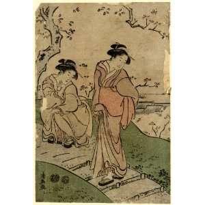 women viewing cherry blossoms from a footpath above a village. Hanami 