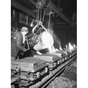 Worker Pouring Hot Steel into Molds at Auto Manufacturing Plant 