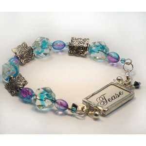  Tease charm on blue beaded bracelet 