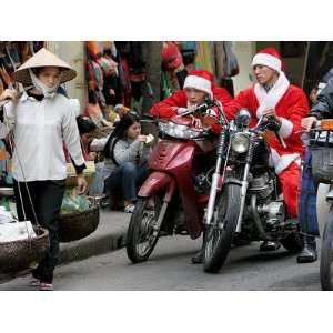  Vietnamese Men Dressed as Santa Claus Wait on their Motorbikes 