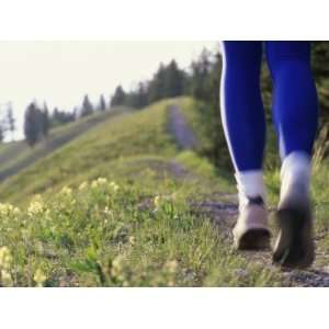  Ground Level View of Jogger on a Trail Premium 